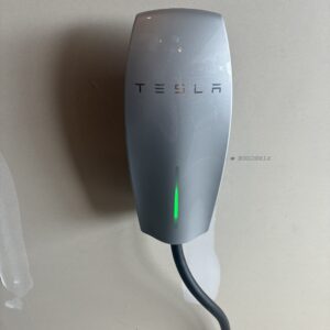 Tesla EV charger with a green indicator light, featured on a page about Recessed Lighting Installation in Kent County.