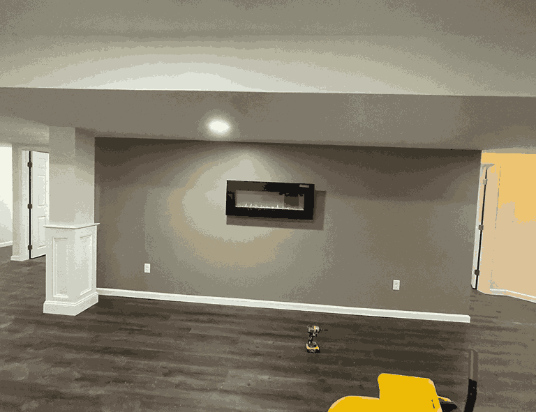 Modern basement featuring recessed lighting installation and a mounted wall unit,