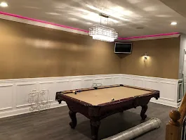 Billiards room with decorative ceiling chandelier